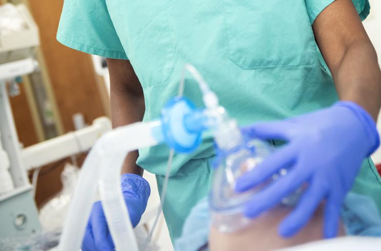 Close up of anesthesiologist administering anesthesia